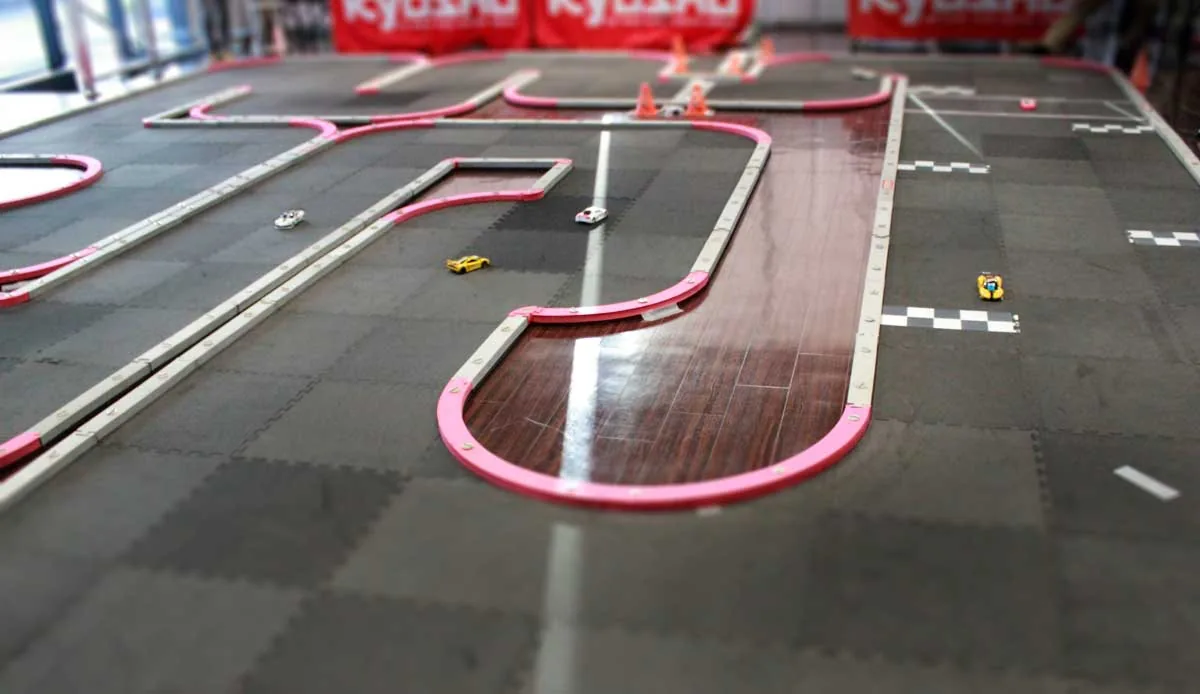 A Mini-Z Grand Prix circuit laid up with kerbs and barriers